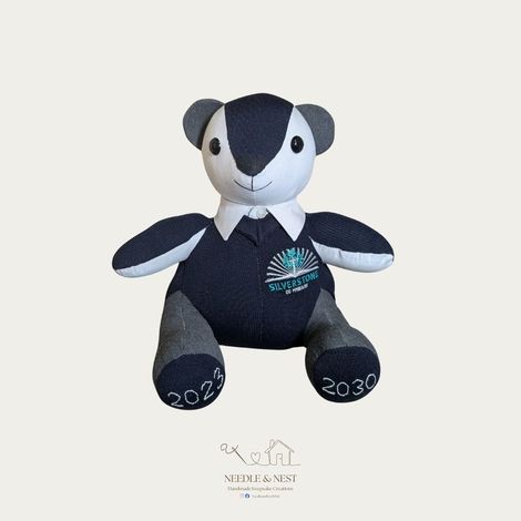 School uniform memory bear by Needle and Nest made from Silverstone CE Primary navy jumper and grey trousers with embroidered year dates 2023 and 2030