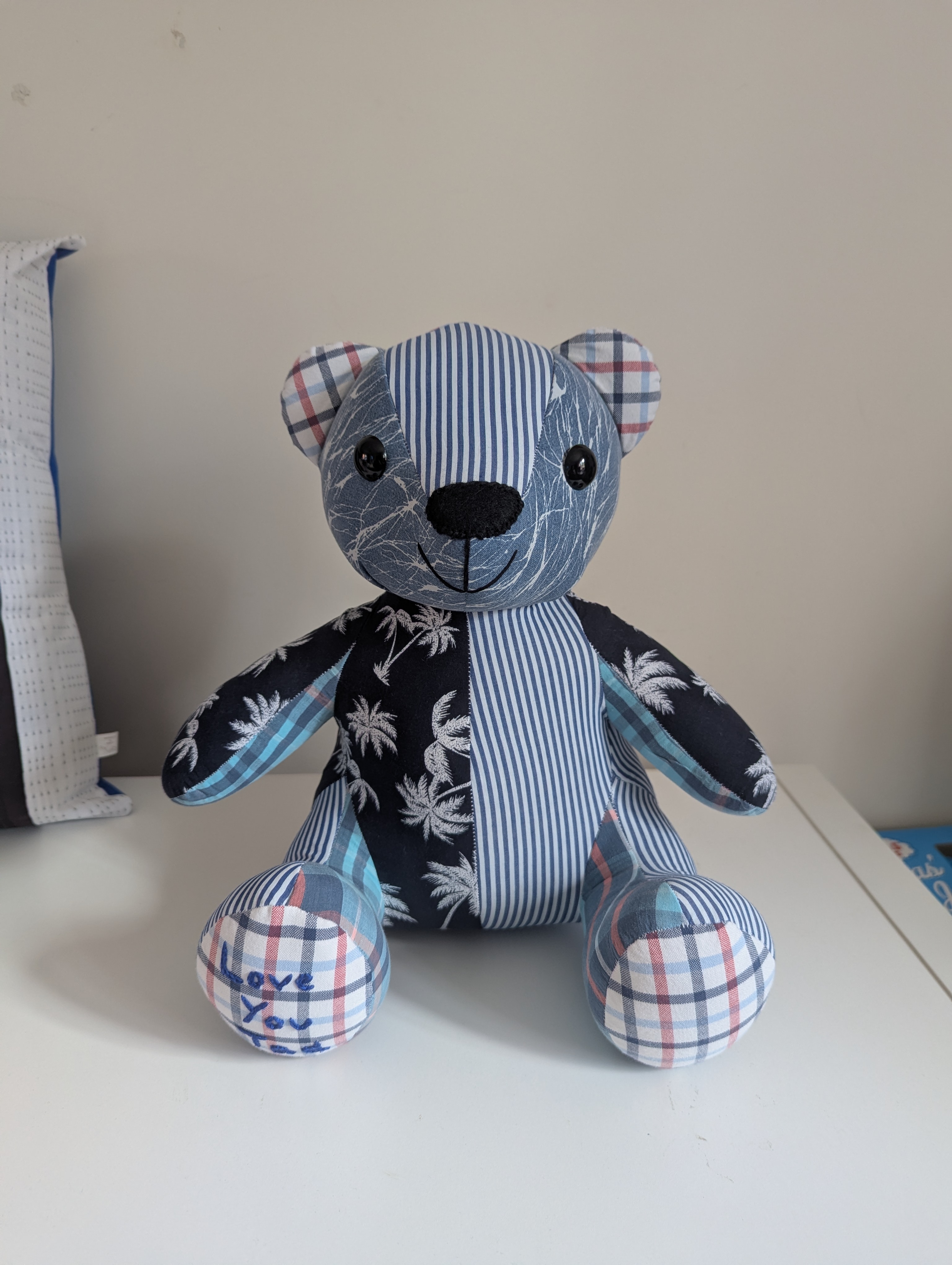Memory bear cushion keepsake made from blue striped and palm tree print clothing