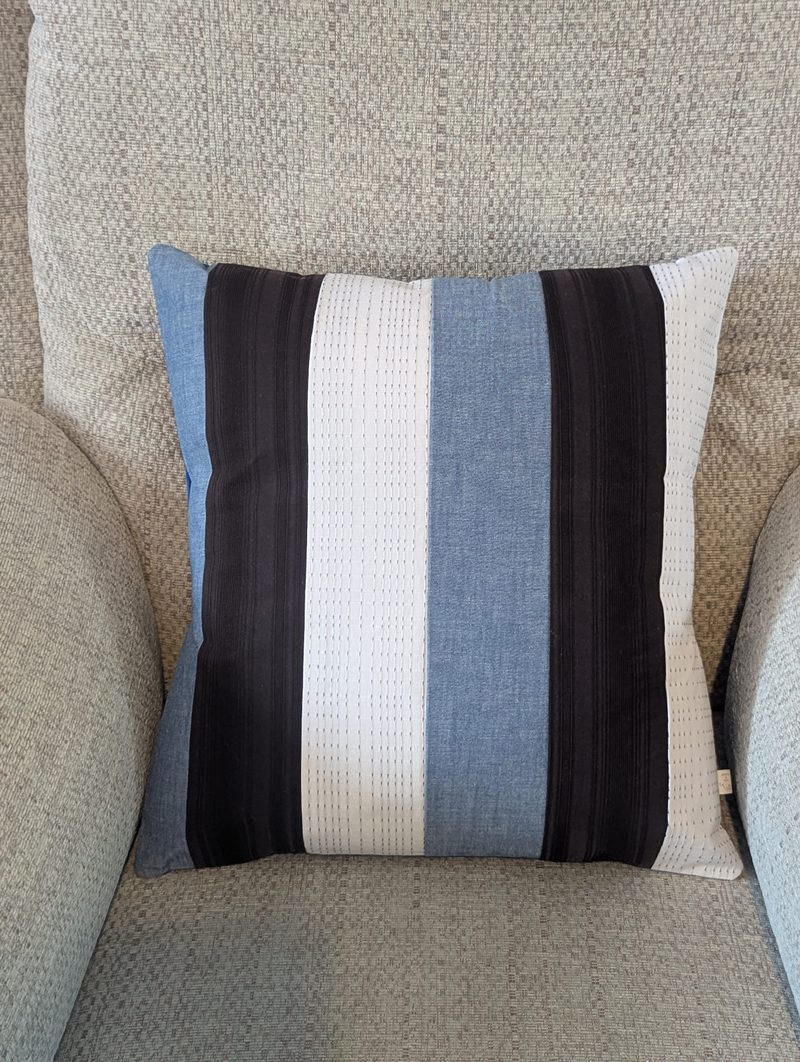 Handmade memory cushion by Needle and Nest created from striped clothing in blue, black and cream with plain backing
